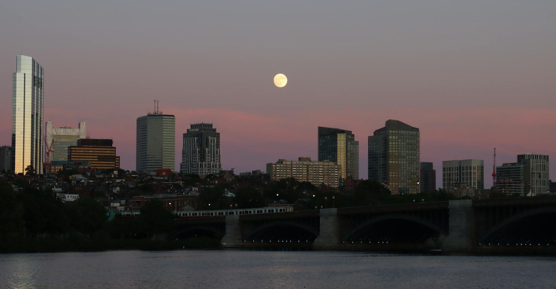 Luxury Boston skyline with waterfront condos at sunset