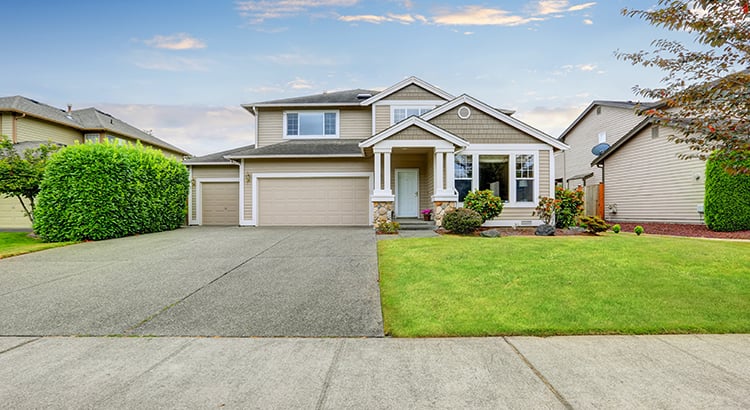 Neat beige home with two garage spaces.