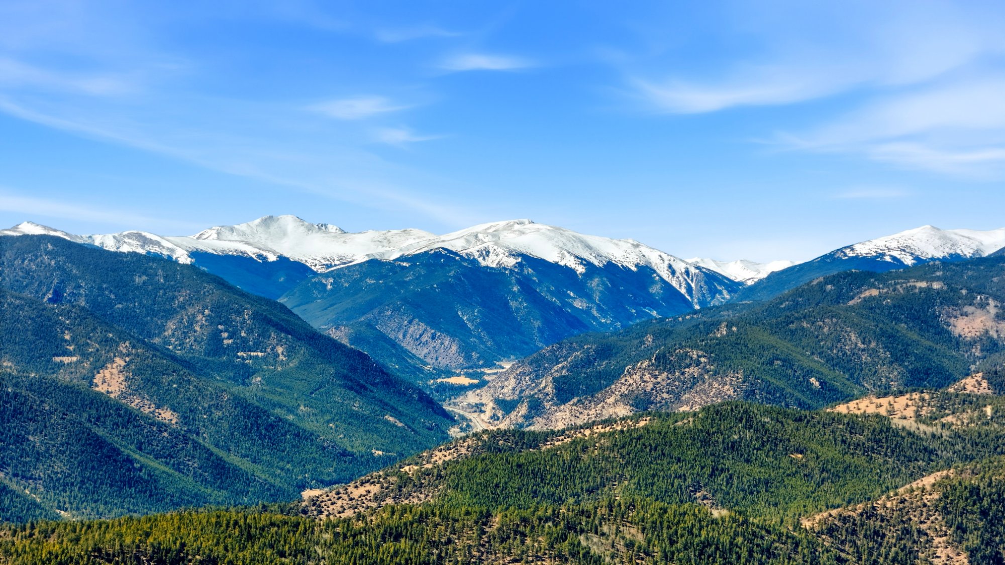 Snowcapped peaks above forested mountain valleys in Clear Creek County, Colorado