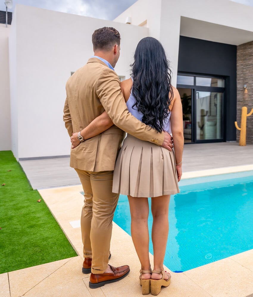 couple-standing-in-the-garden-of-their-new-luxury-2023-12-08-21-24-19-utc (1)