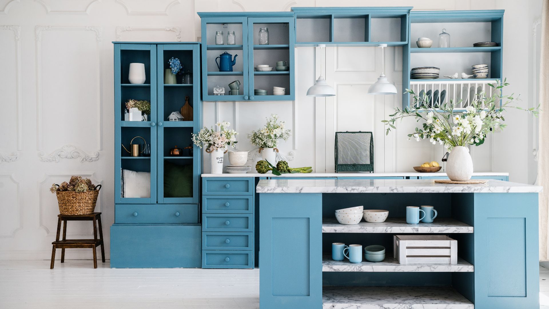 Kitchen in scandinavian style with island table, blue furniture and modern kitchenware