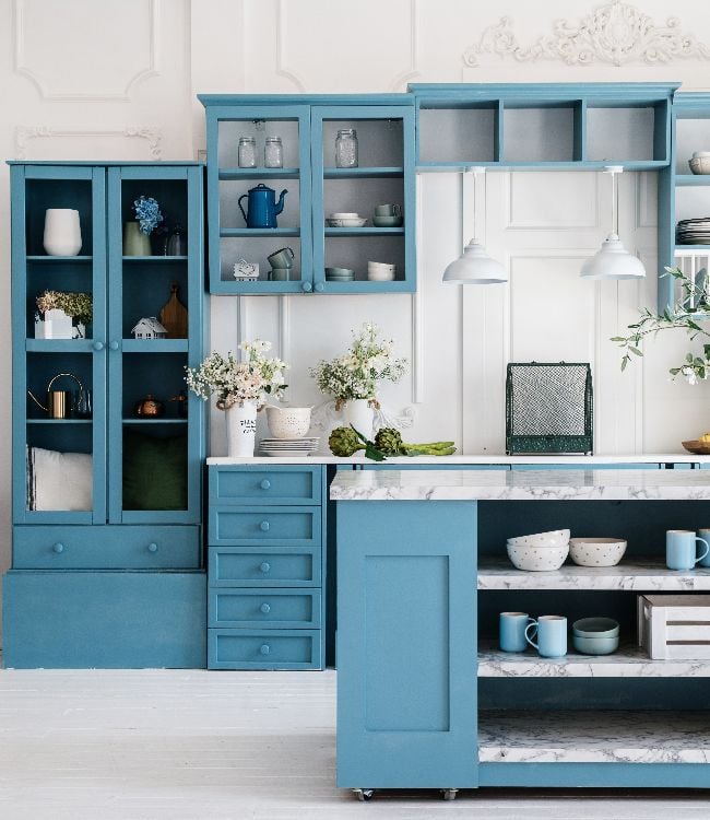 Kitchen in scandinavian style with island table, blue furniture and modern kitchenware(1)