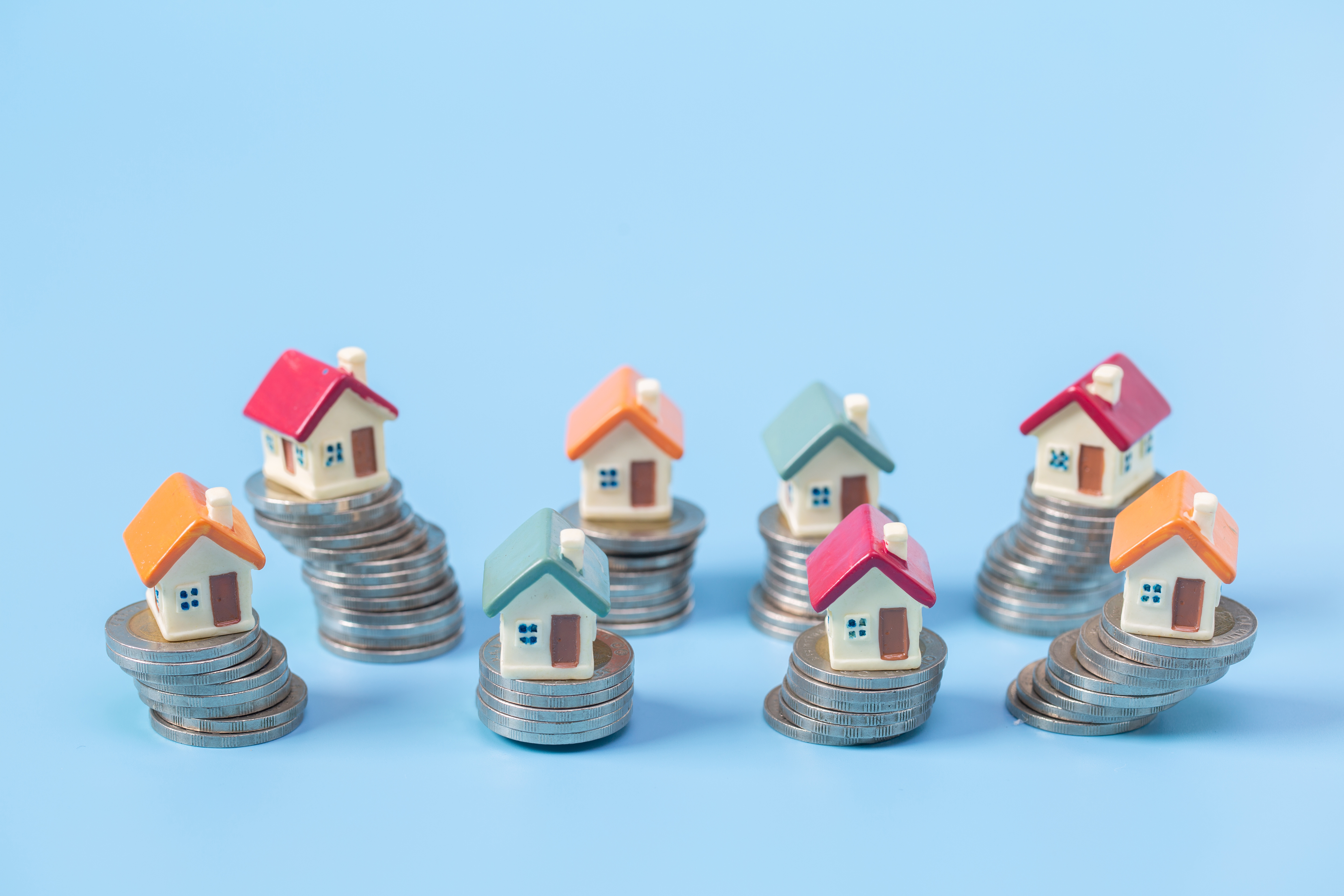 Mini house on stack of coins,Money and house, Real estate invest