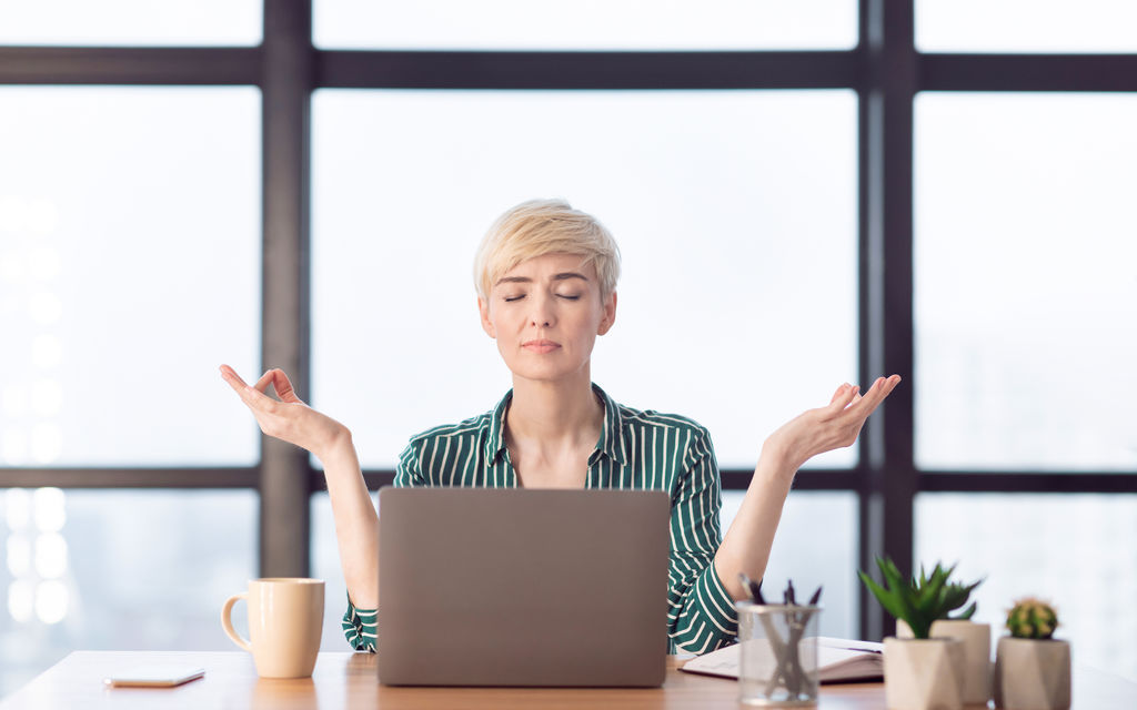Peaceful Businesswoman Relaxing Meditating Sitting At Workplace In Office