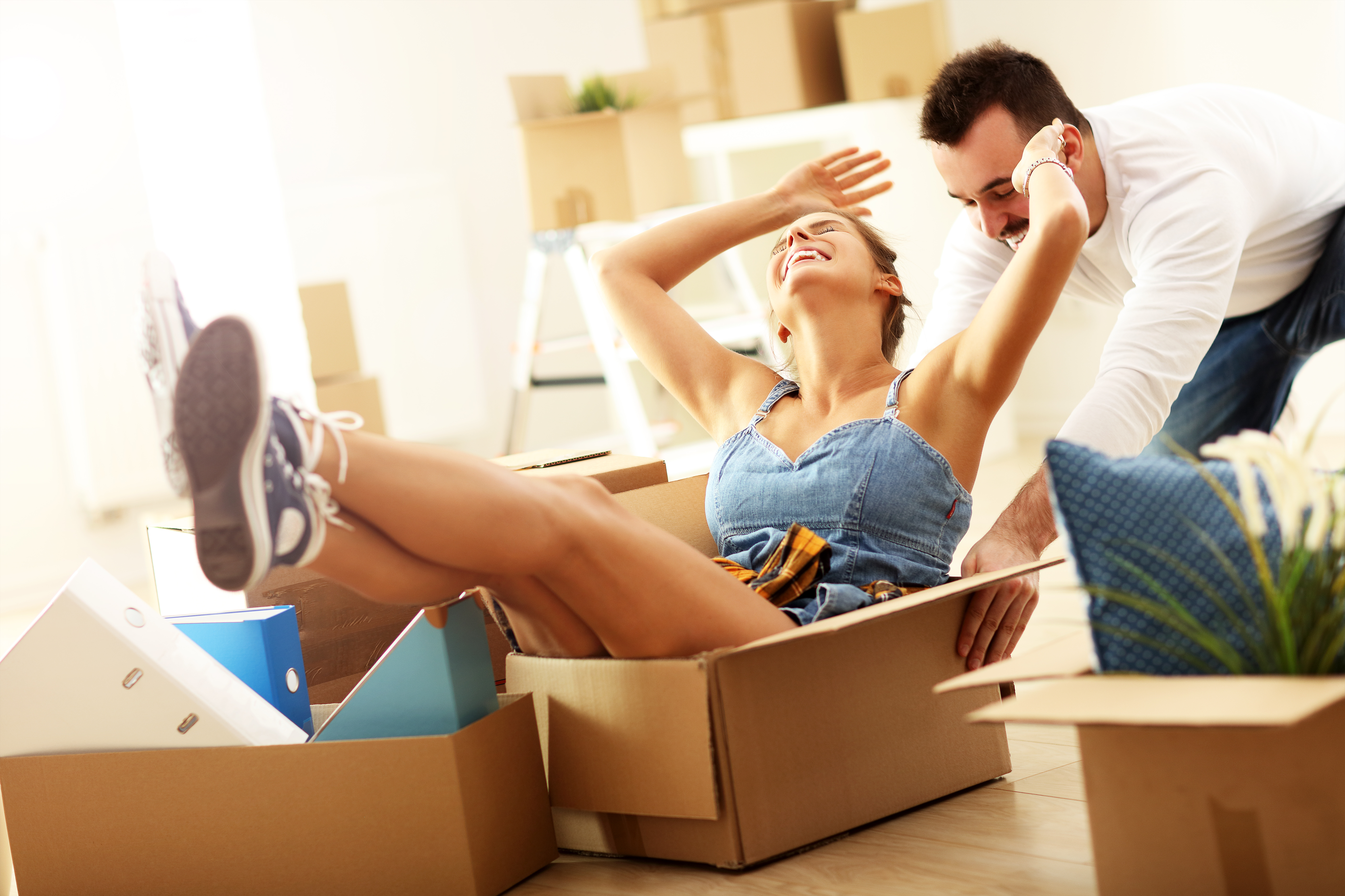 Happy adult couple moving out or in to new home