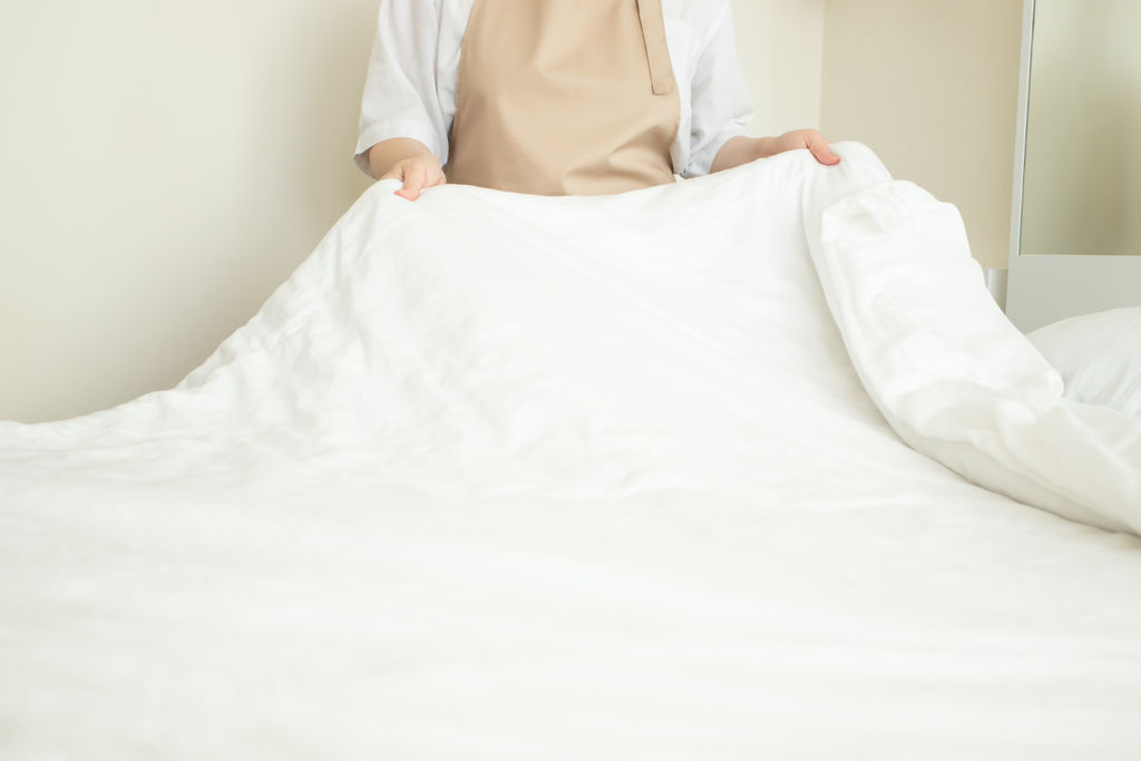 making bed, hotel room service, housekeeping, cleanliness in the bedroom