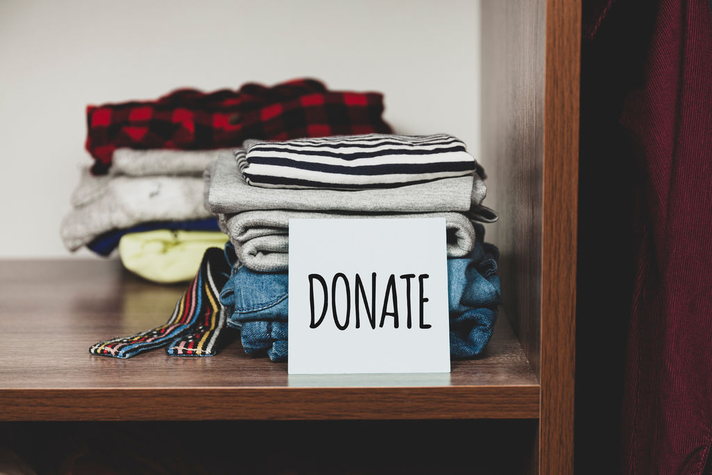 Stack of old clothes to discard (declutter) or donate. Recycling