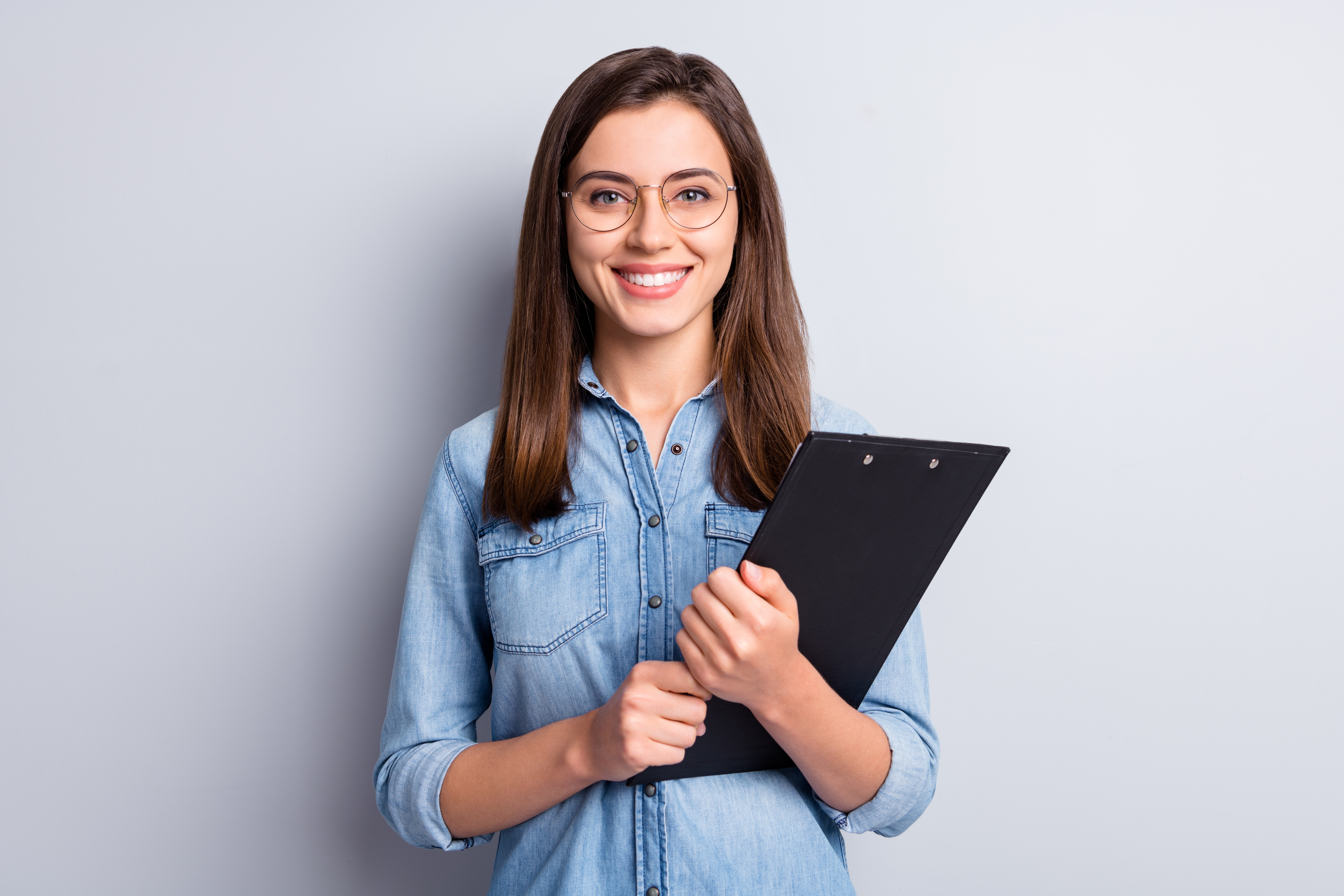 Portrait of adorable young business person hands hold clip board isolated on grey color background