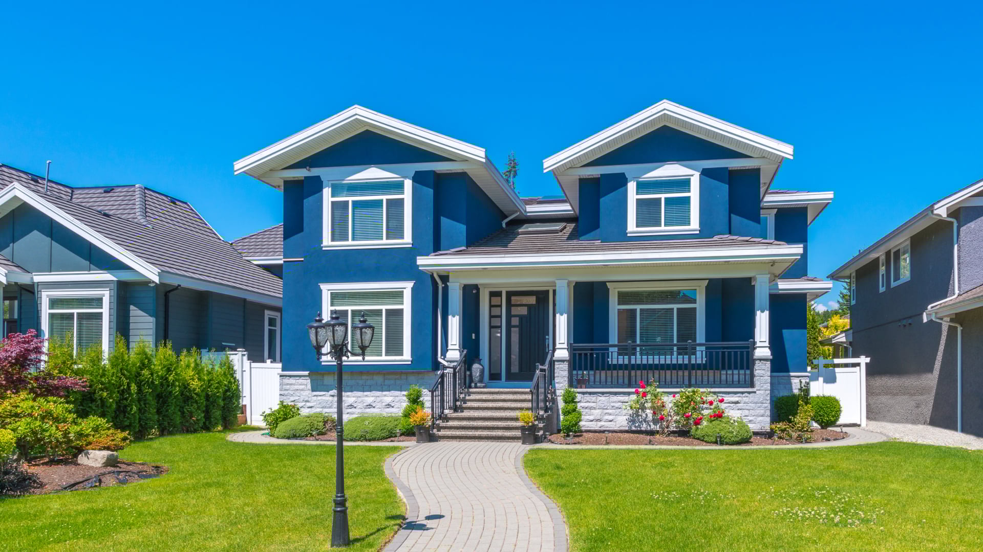 Blue luxury house with nicely trimmed and landscaped