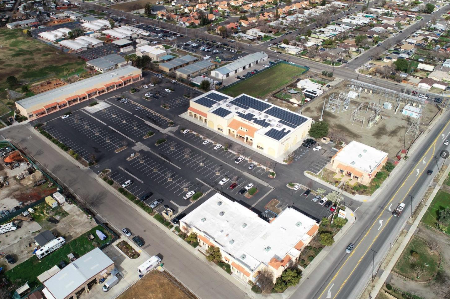 Aerial view of shopping center parking lot adjacent to subject property