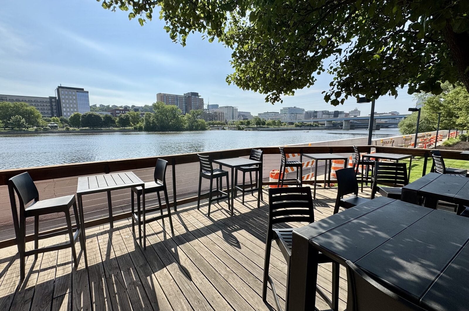 Outdoor riverside terrace with seating and downtown Grand Rapids skyline views near the Smallegan Real Estate office