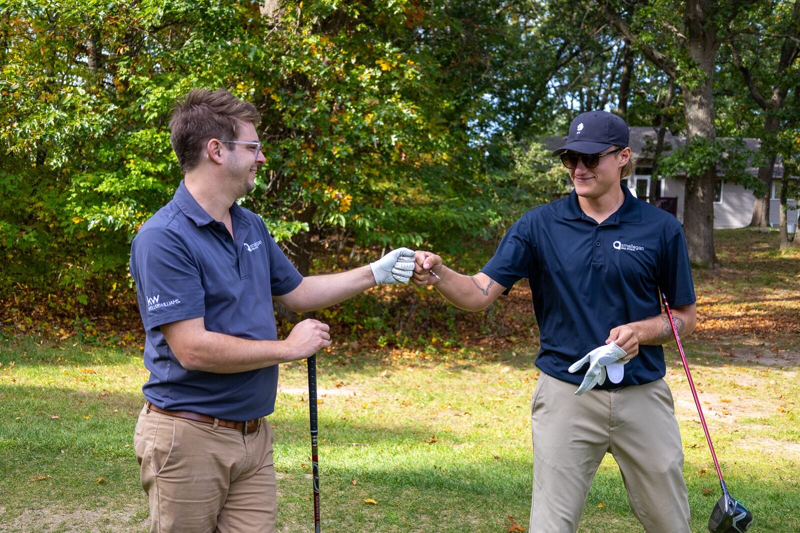 Smallegan Real Estate team members high-fiving during the Cougar Classic golf outing