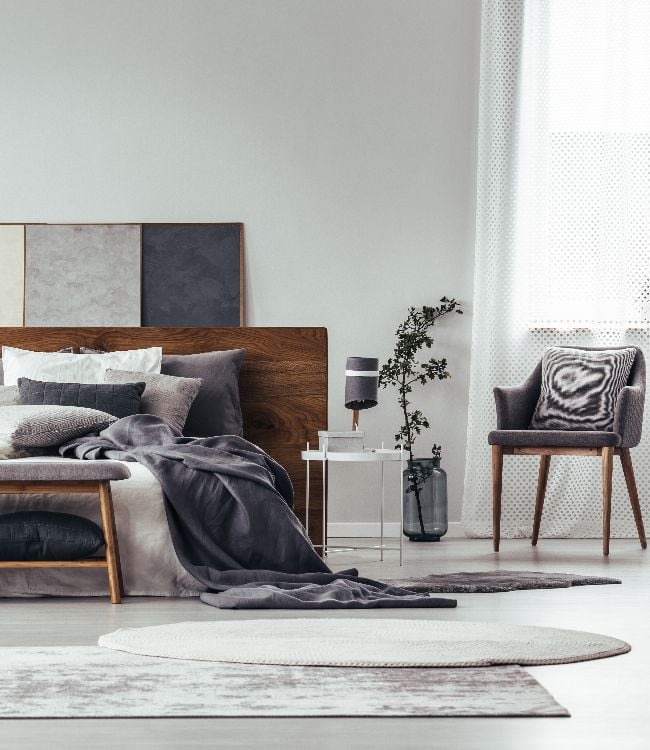 grey bedroom interior with rugs, bench and chair(2)