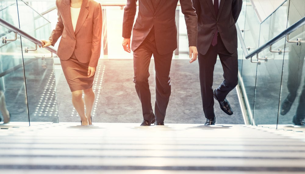 Business persons going up the stairs.