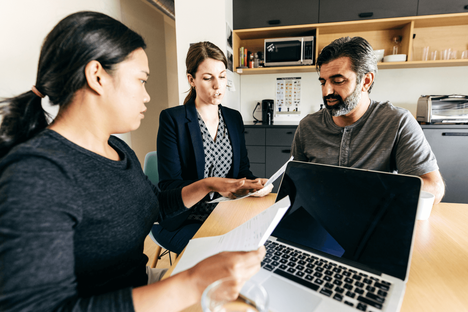First-time home buyers reviewing mortgage preapproval documents with a lender