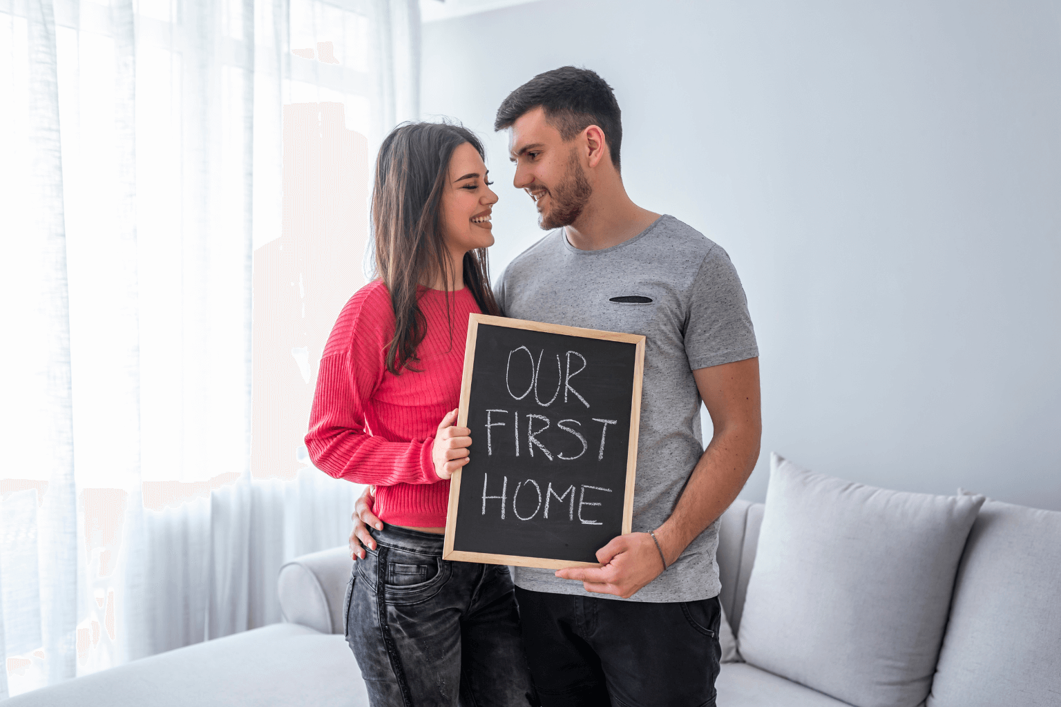 First-time homebuyers standing in front of a new house in San Ramon