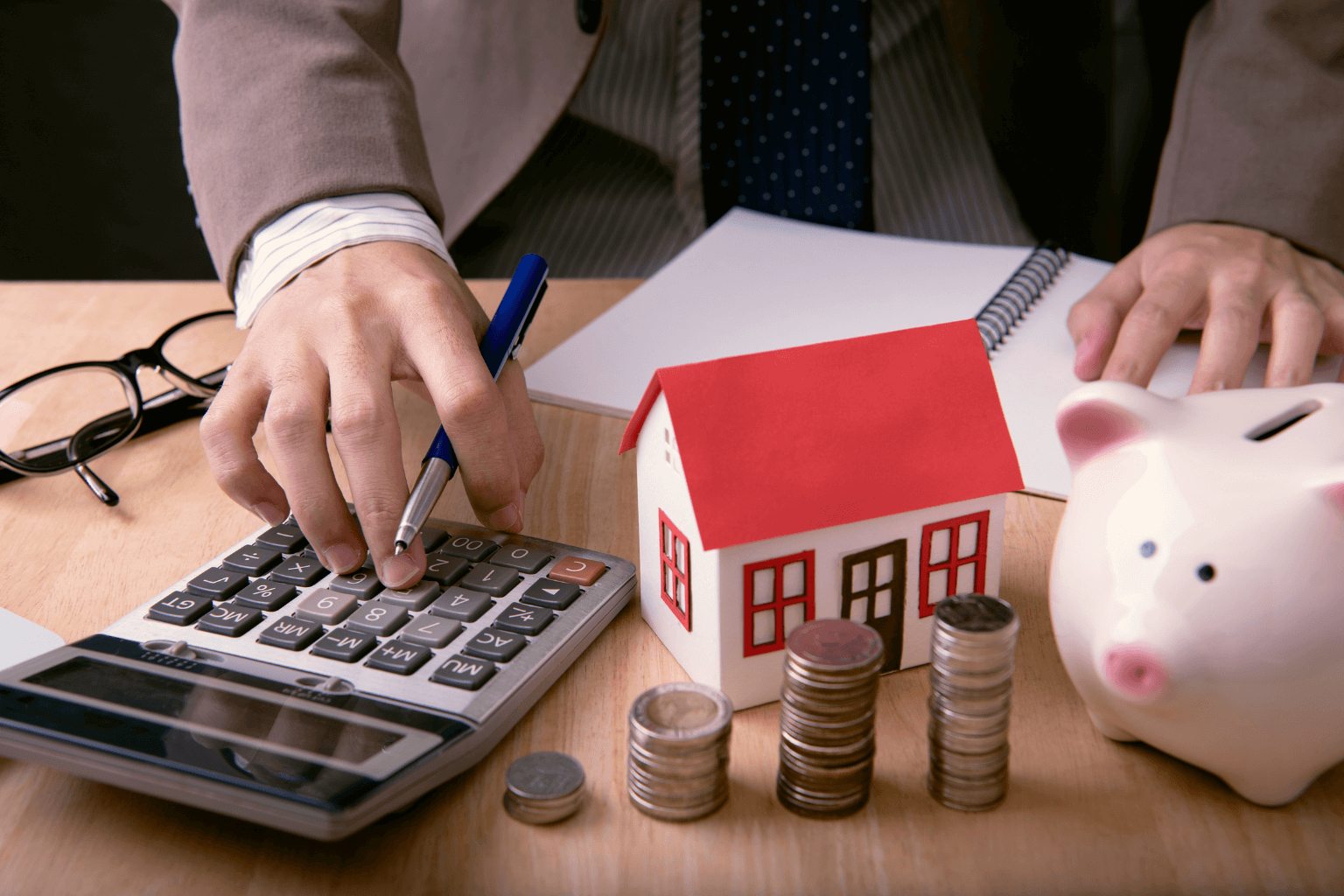 Home budget planning with calculator and house model