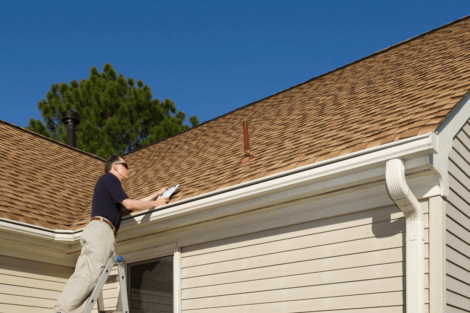 Home inspector evaluating a house exterior