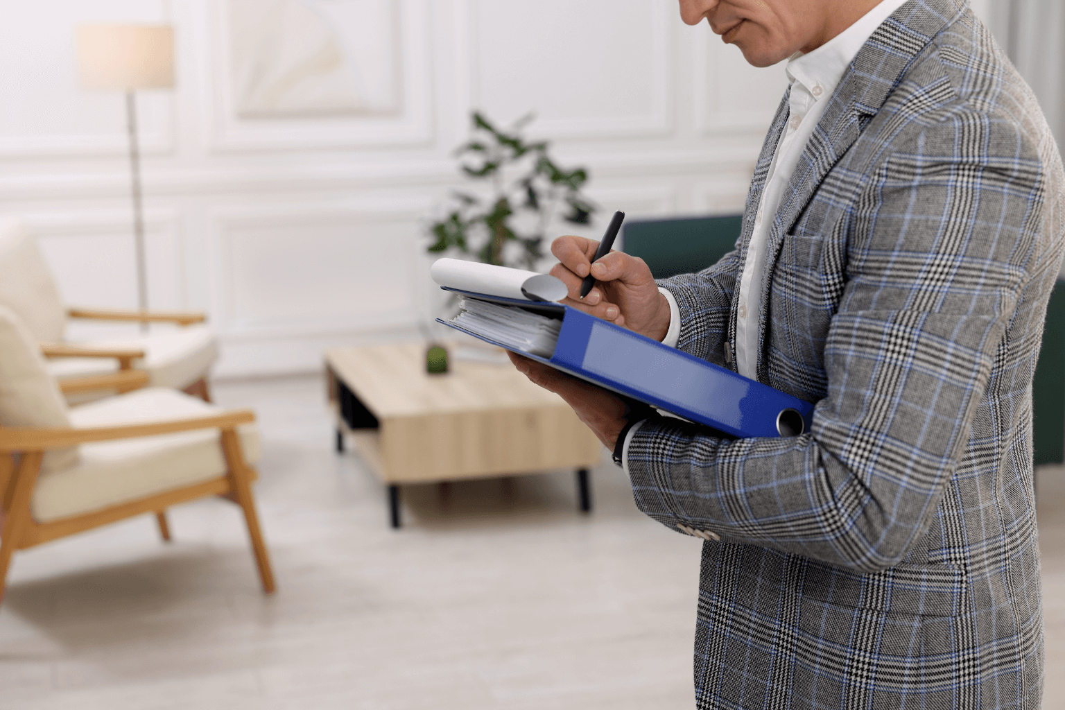 Home inspector examining exterior of a house