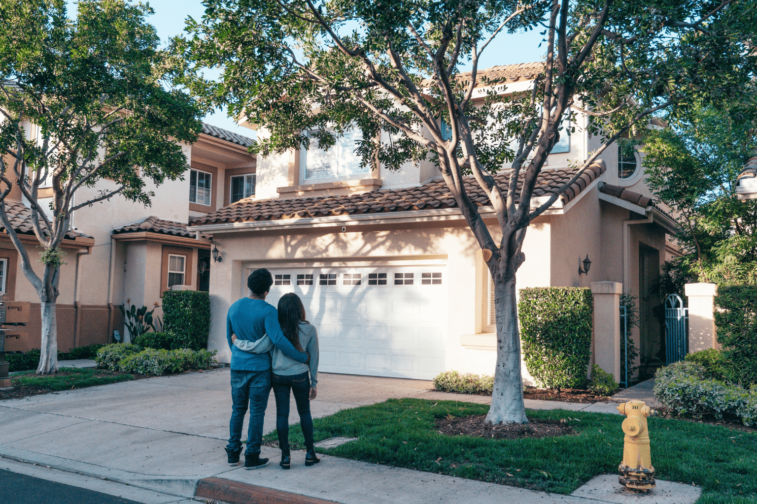 Couple walking through a Lafayette neighborhood researching homes