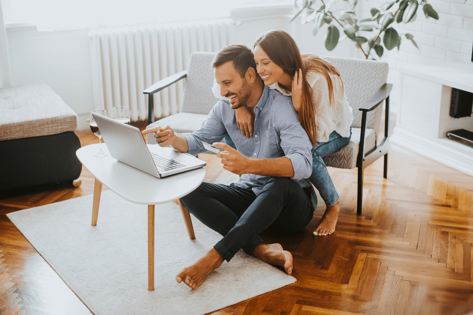 Couple looking at a real estate listing on a laptop