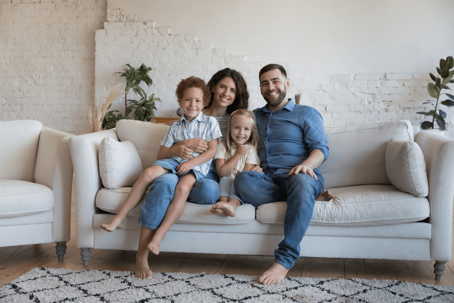 Happy homeowners sitting in their new living room