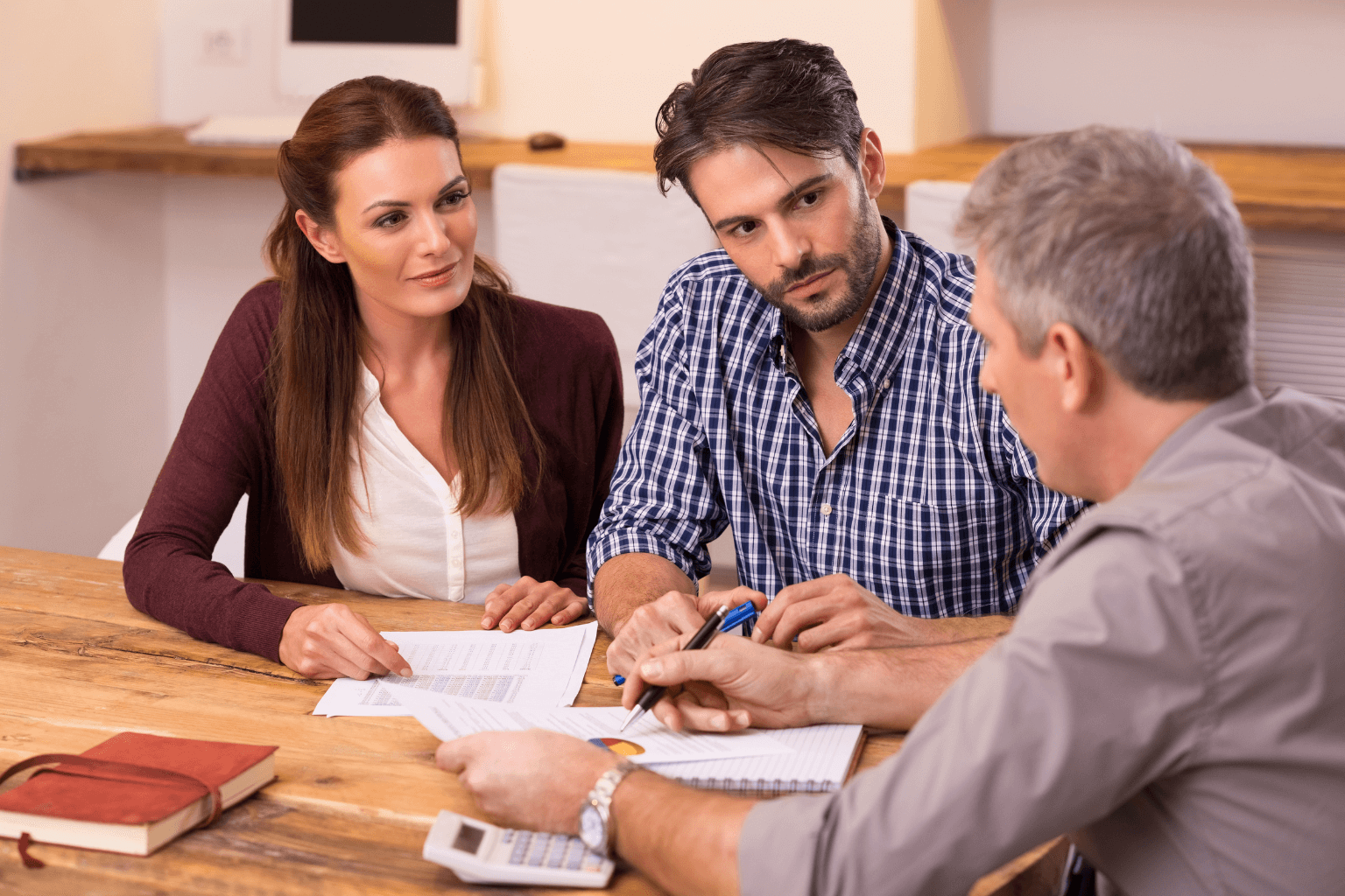Young couple reviewing creative home financing documents