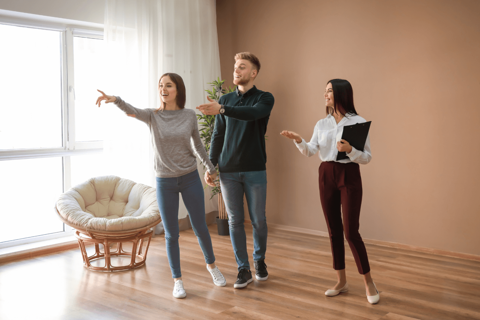 Couple touring a home for sale with a real estate agent