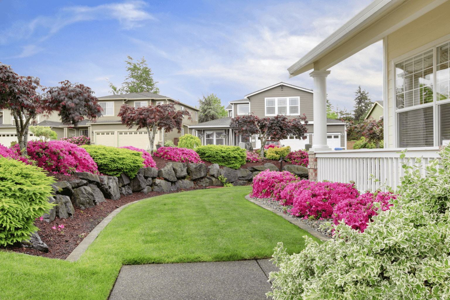 House with fresh landscaping and colorful flowers out front