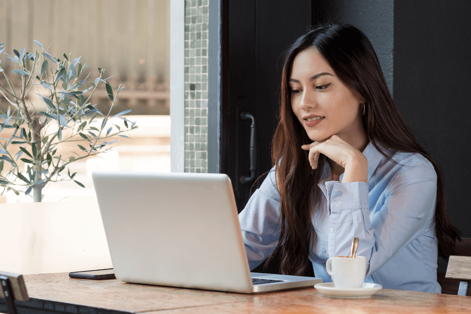 Business owner checking email marketing stats in San Ramon office