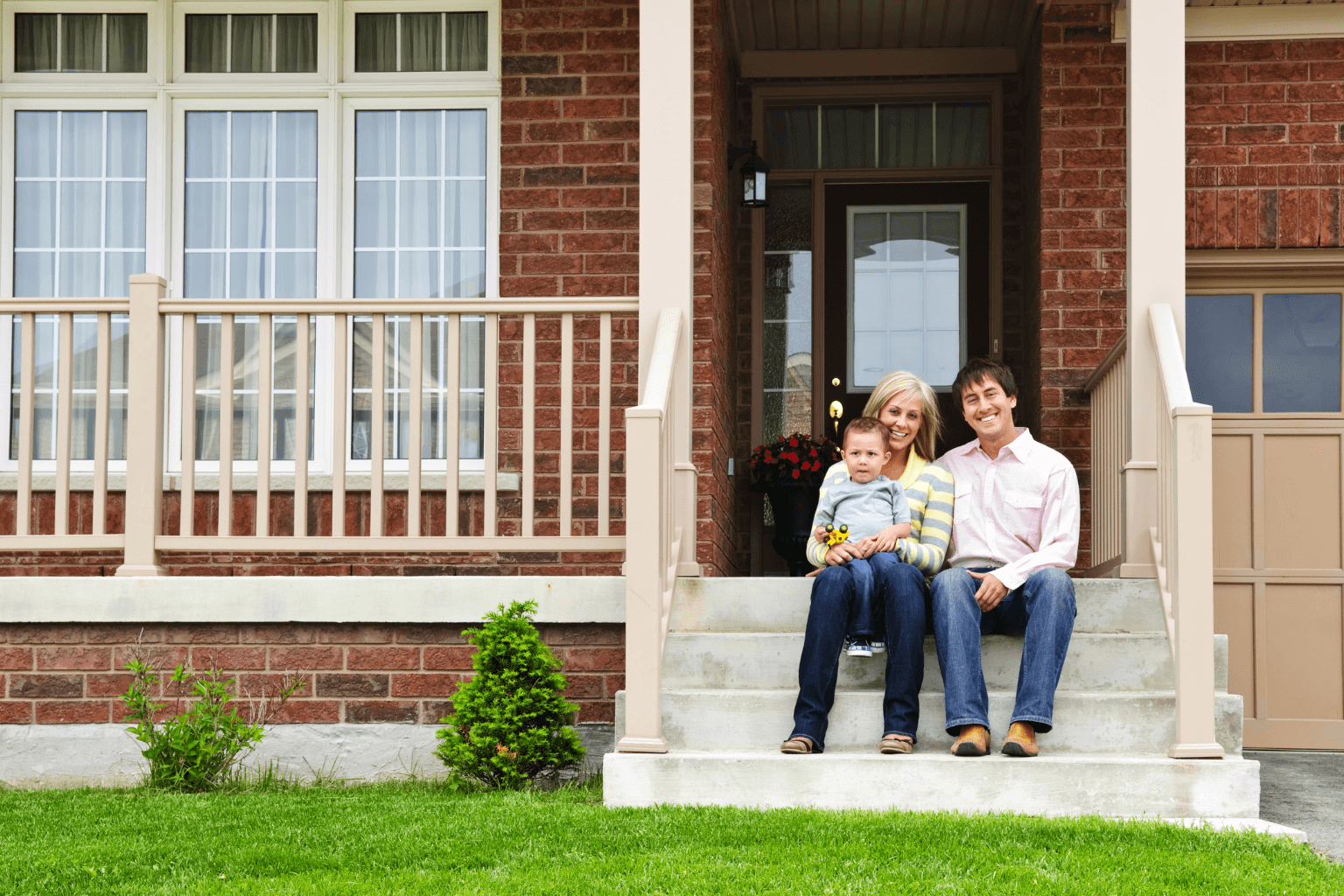 Happy family in front of their new home