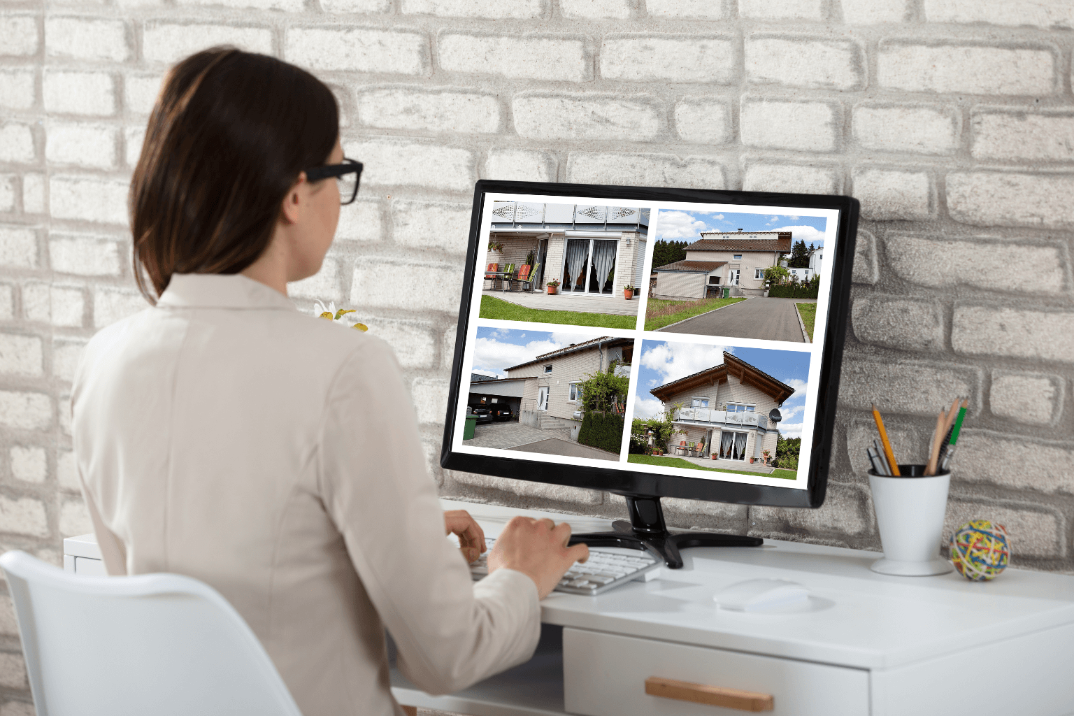 Woman looking at home listings on computer