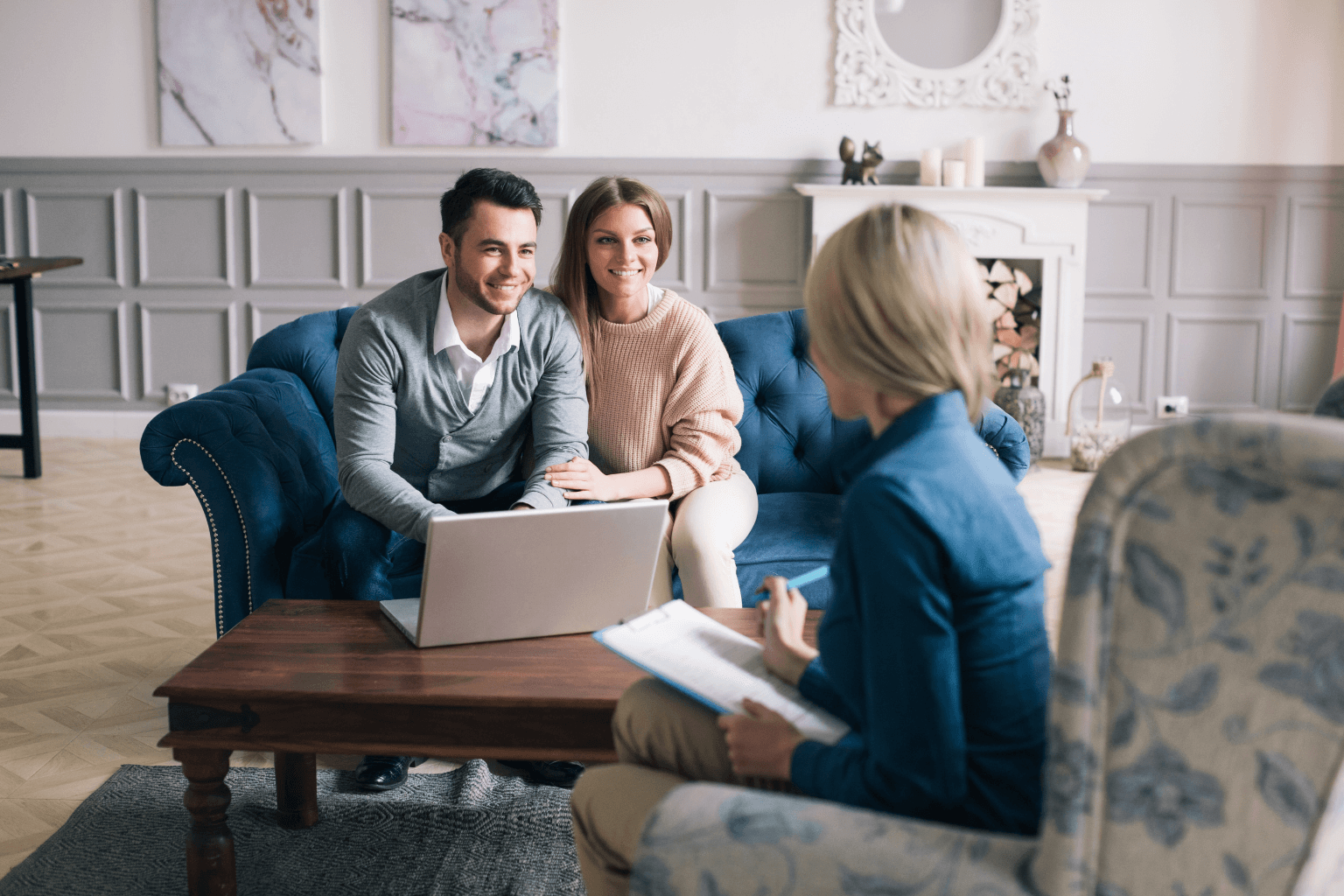 Young couple reviewing home buying steps with a real estate agent