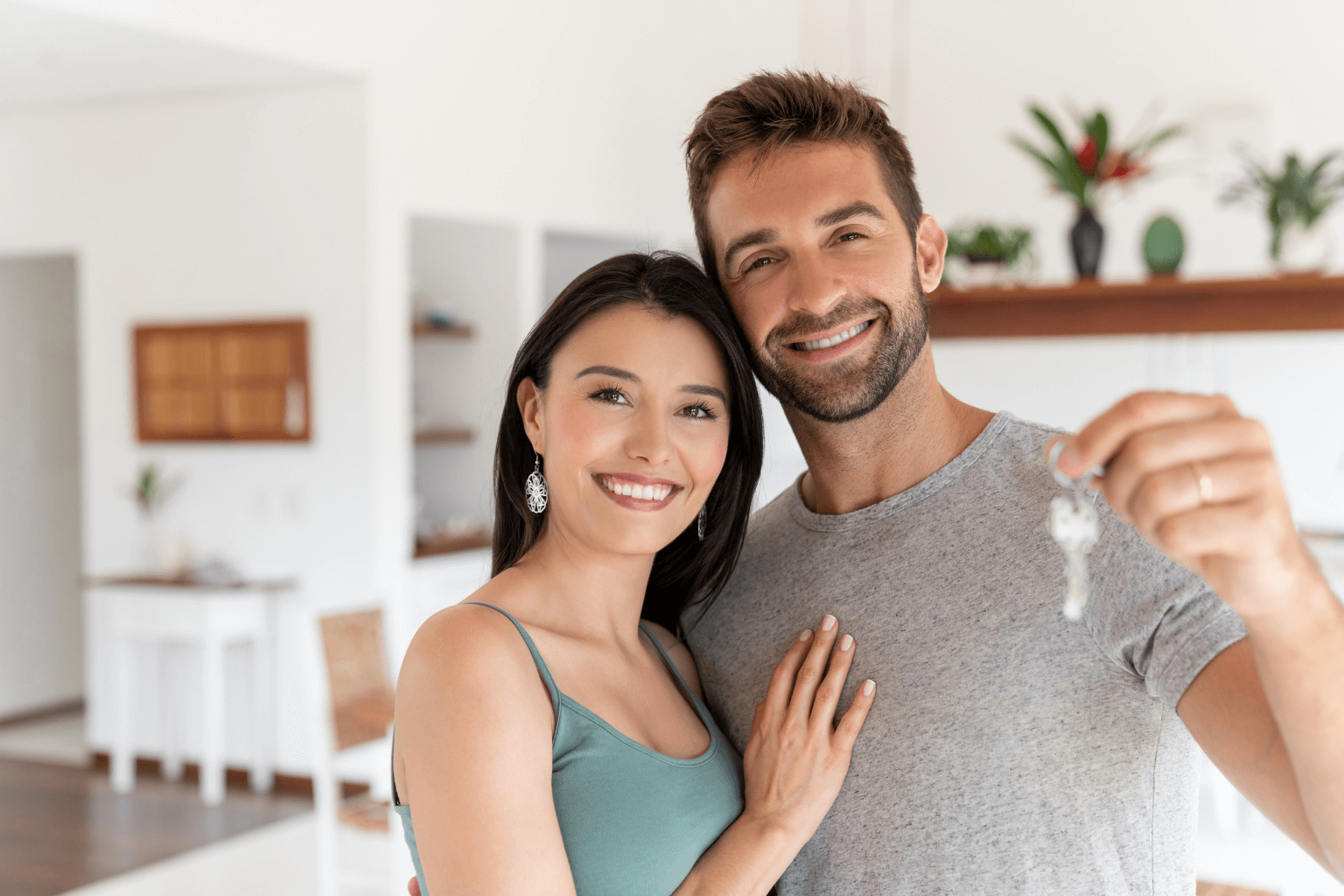 Smiling home buyer holding house keys in Concord, California