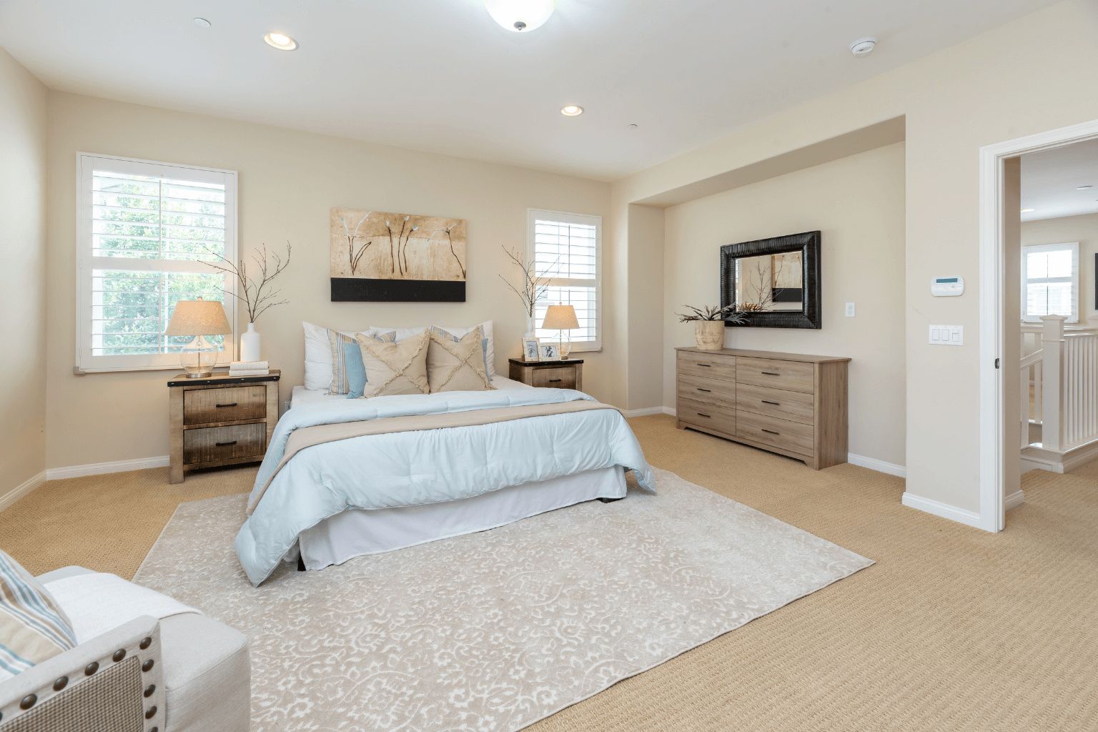 Staged bedroom with neutral colors and fresh bedding