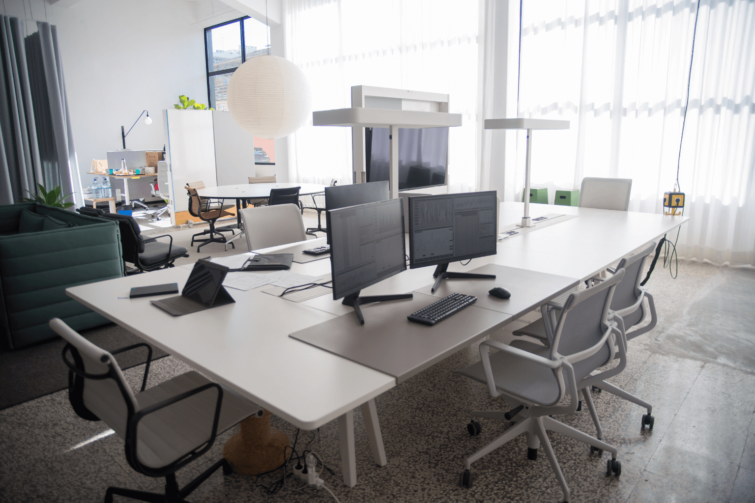 Bright modern real estate office with desk and laptop