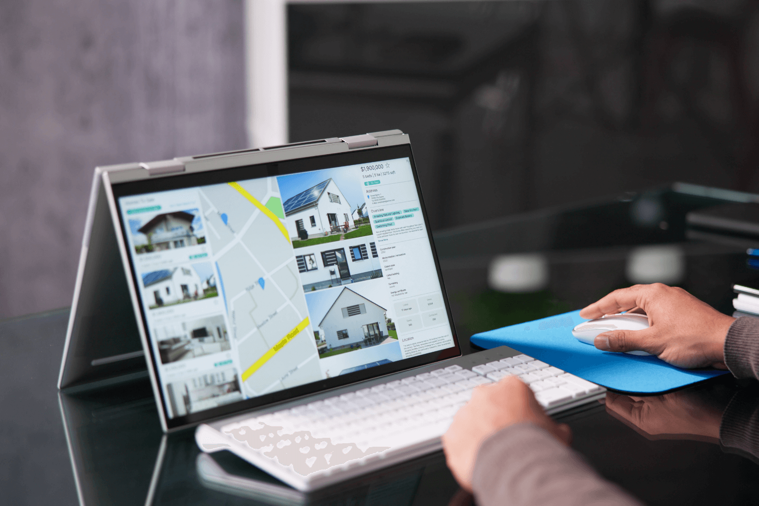 Laptop open with housing listings on screen
