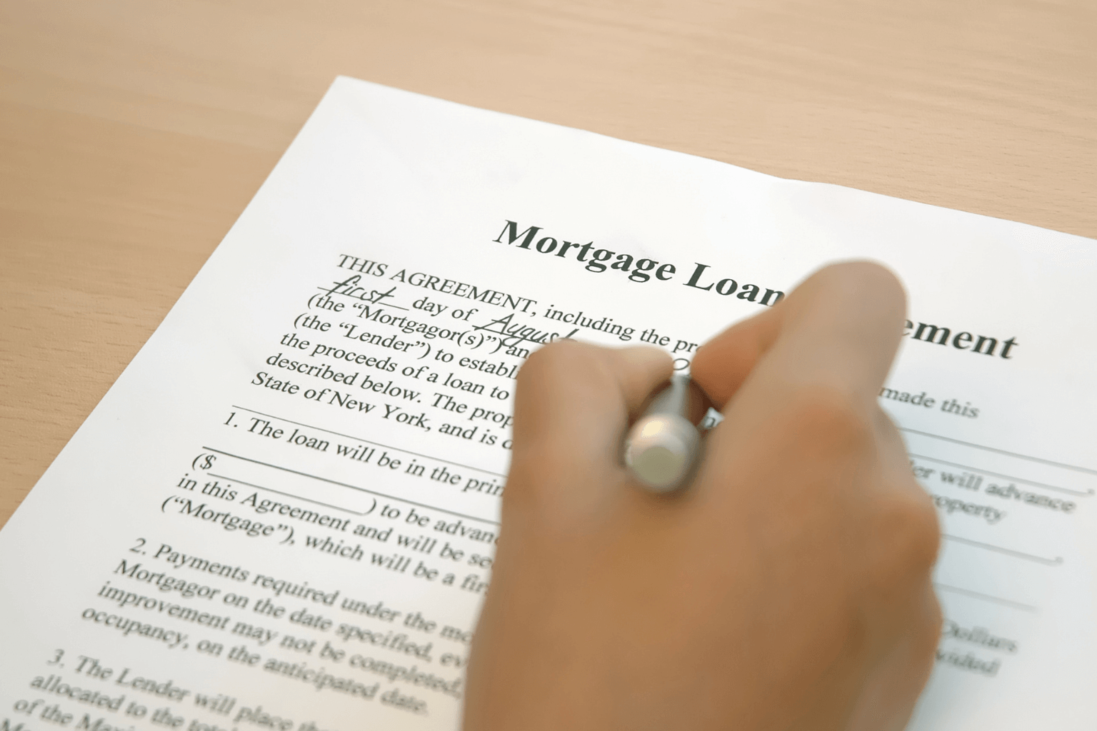 Homebuyer signing mortgage papers