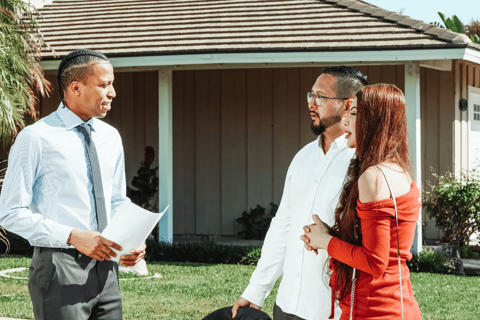 A realtor talking to a client in front of a house in Orinda