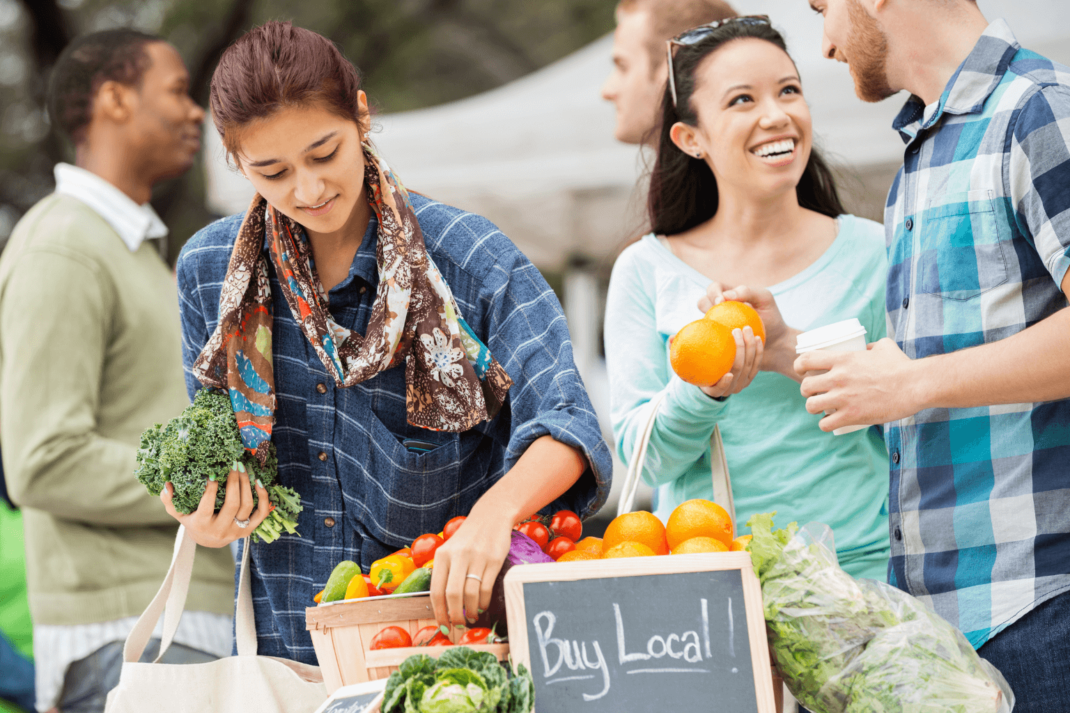 People enjoying a weekend market in Pleasanton with stalls and food vendors.