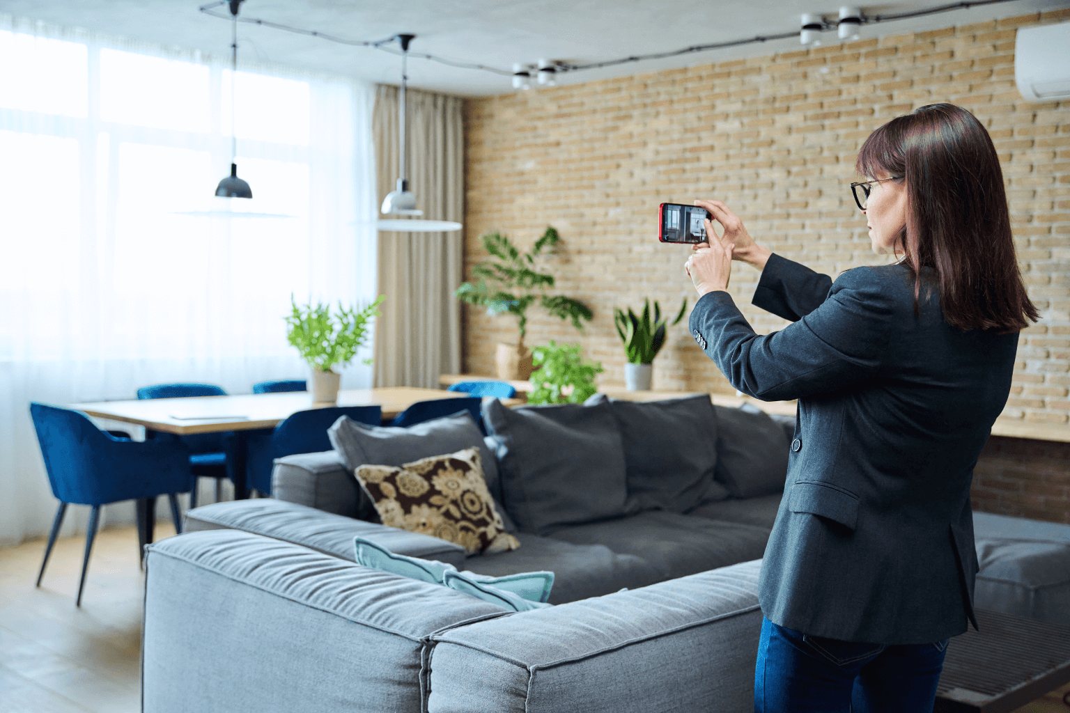 Woman taking pictures of a modern living room