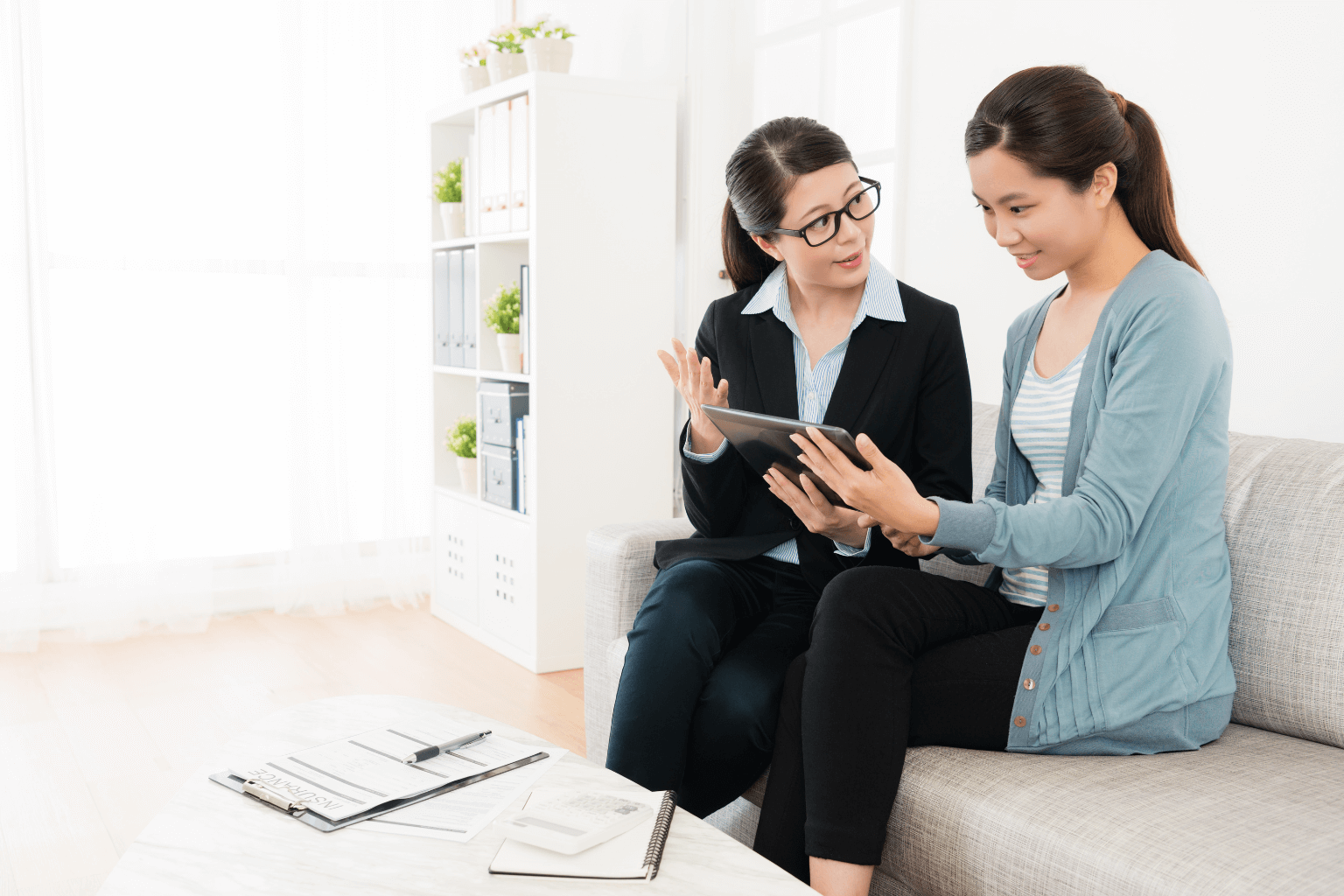 Real estate agent showing a home listing to a client