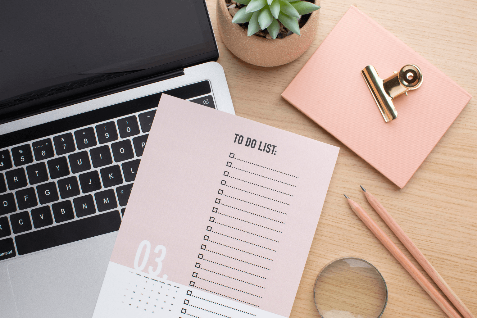 Real estate tools including laptop, folders, and phone on a desk