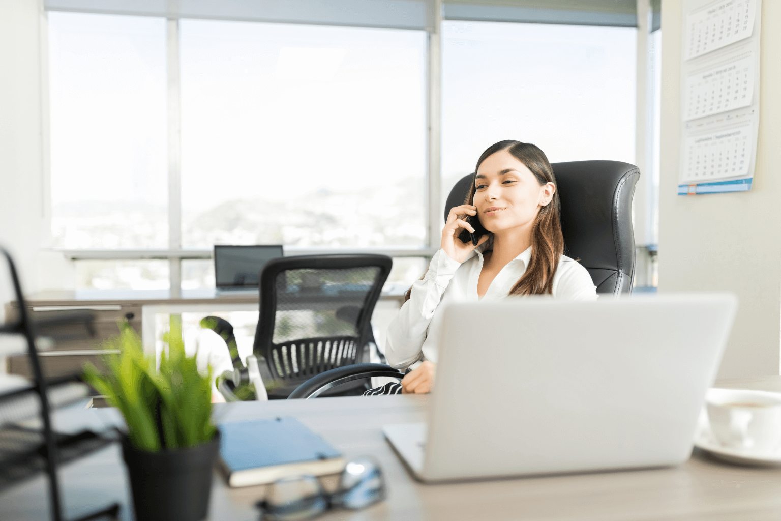 Realtor talking to a client on the phone about a property