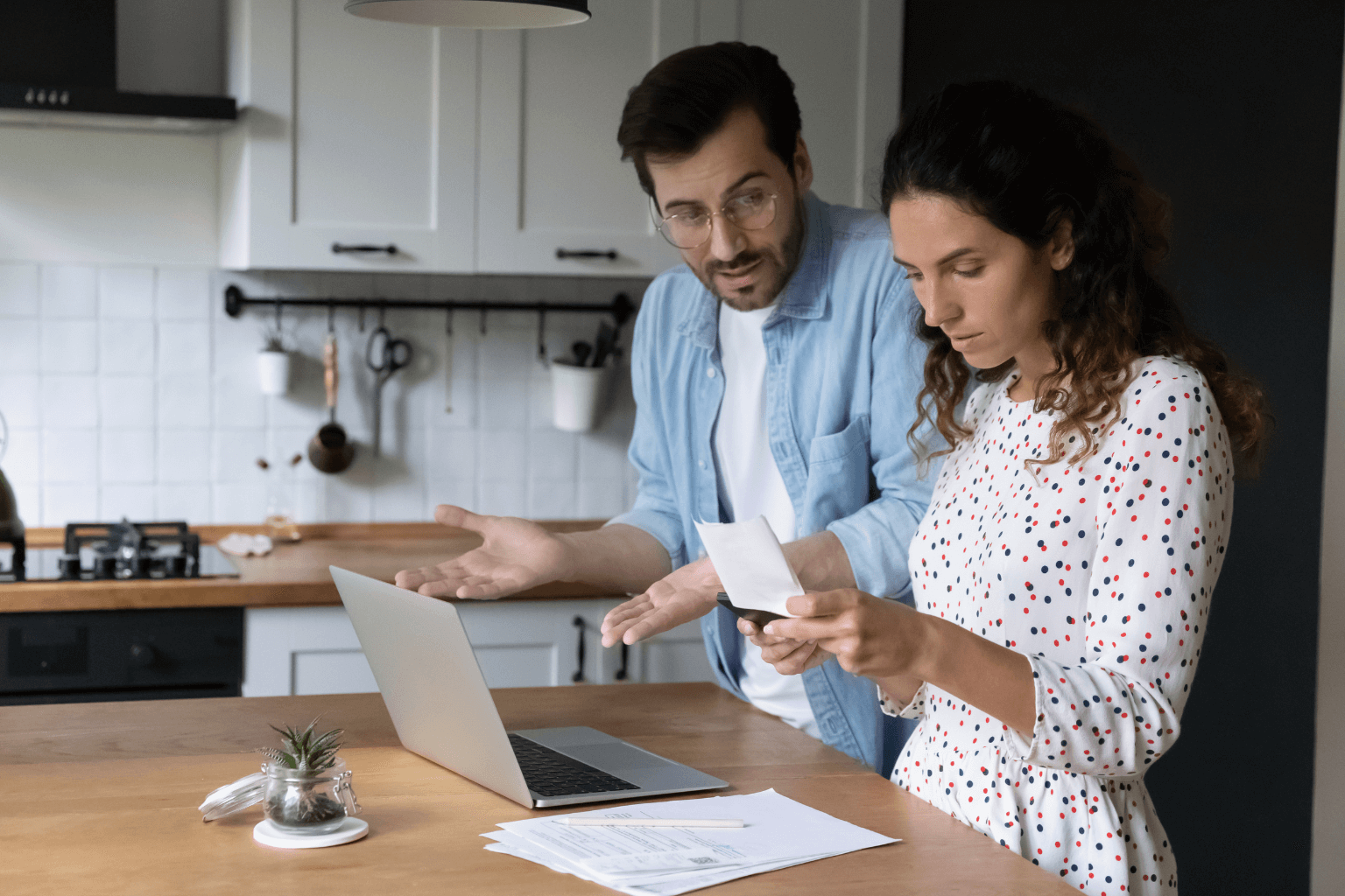 Frustrated couple reviewing home pricing details