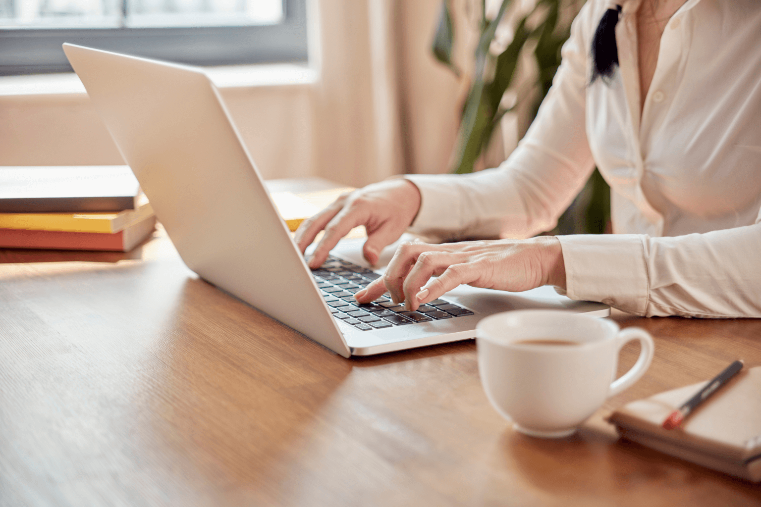 Real estate agent checking listings on a laptop in the morning