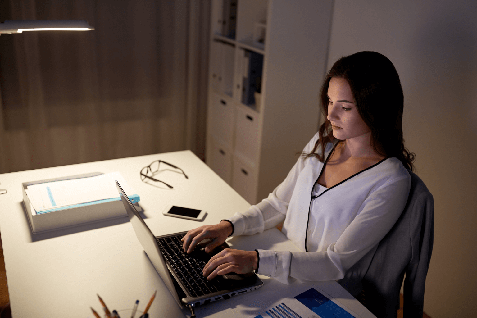 Real estate agent working on paperwork at night