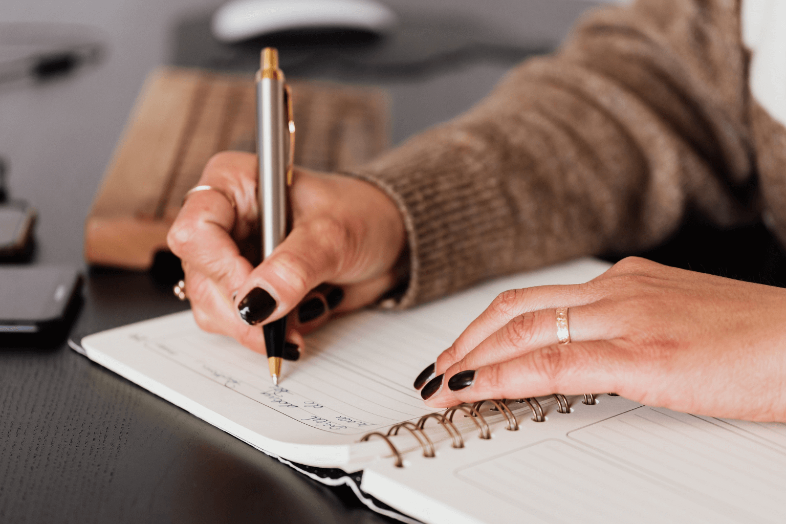 Real estate agent writing in a planner.