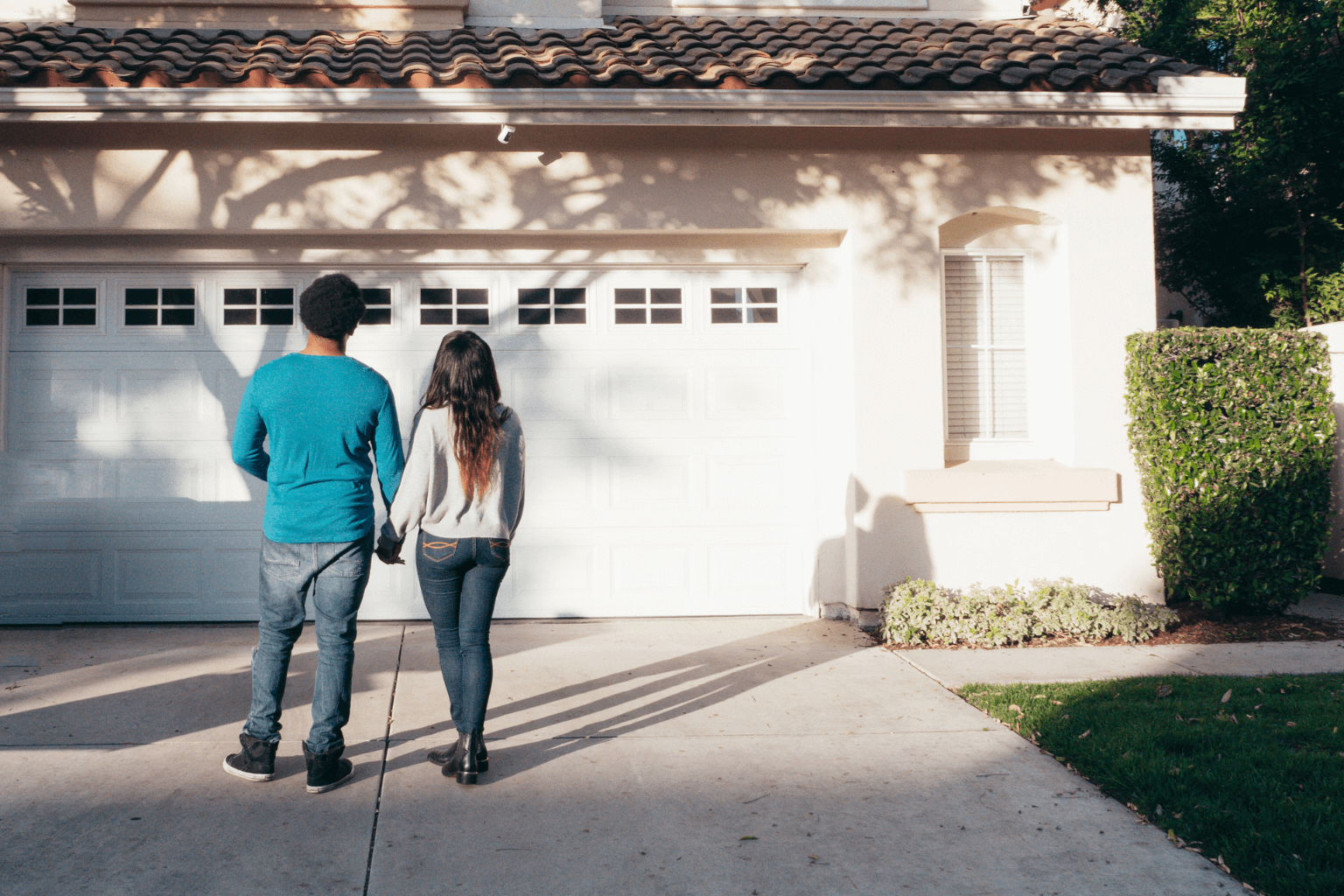 Young couple in front of a rental home