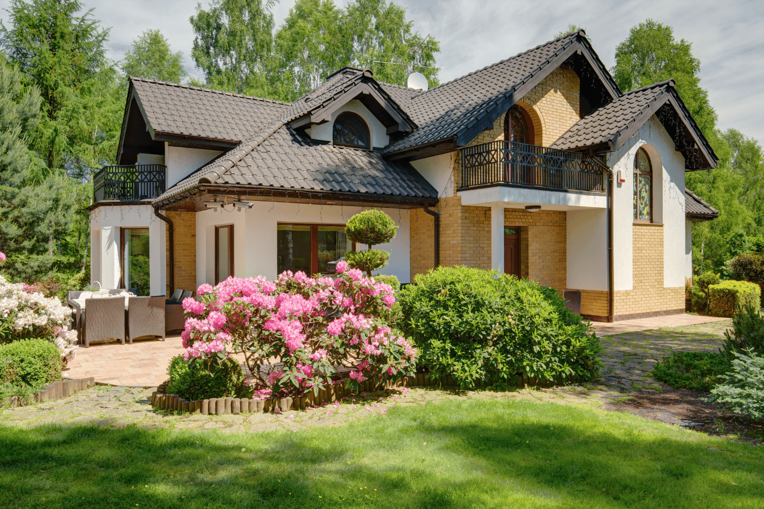 Front view of a home with flowers blooming in spring